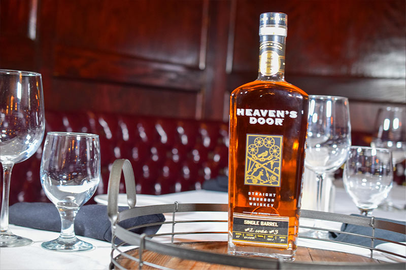 a bottle of Heaven’s Door bourbon on a wooden tray at Christner’s steakhouse