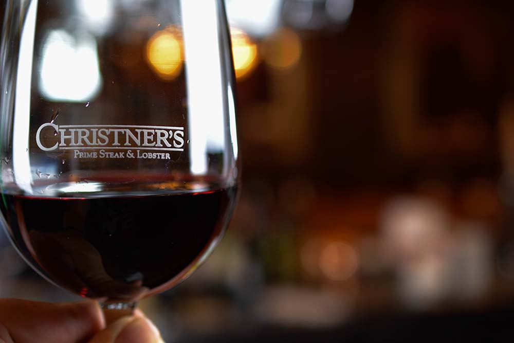 a Christner's glass with red wine in it