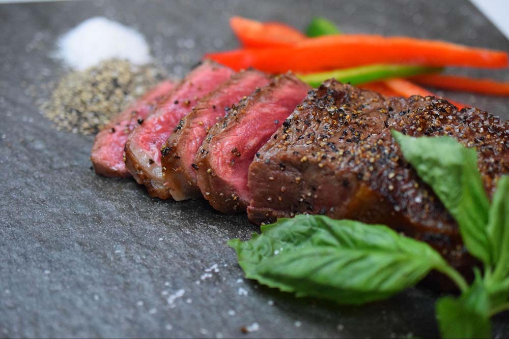 Christner's New York Strip-style steak with peppers and seasoning