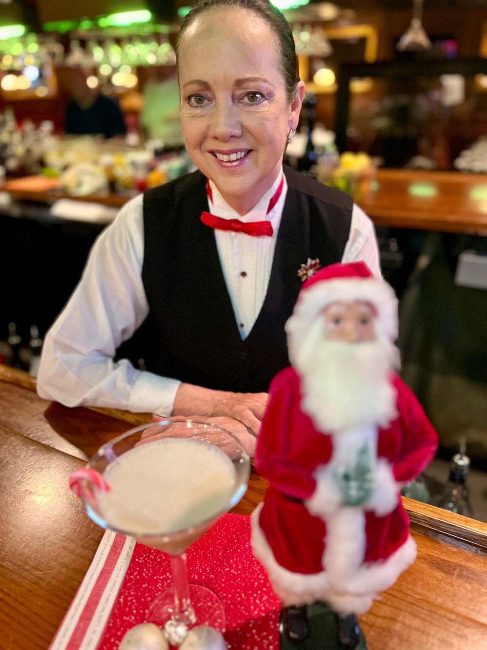 bartender with a Santa Claus and a Christmas Kiss cocktail at Christner’s